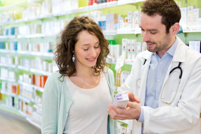 pharmacist with woman customer in the drug store