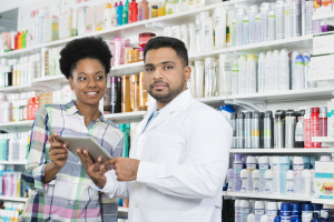 pharmacist with a woman customer holding a tablet 